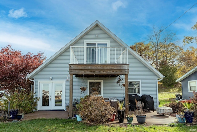 rear view of house with a balcony and french doors