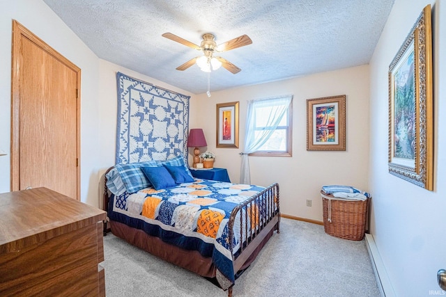 bedroom with carpet floors, a textured ceiling, baseboards, and a ceiling fan