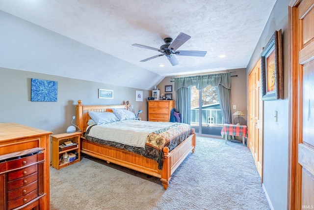 bedroom with baseboards, light colored carpet, lofted ceiling, ceiling fan, and a textured ceiling