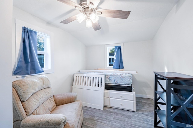 bedroom with ceiling fan, baseboards, vaulted ceiling, and wood finished floors