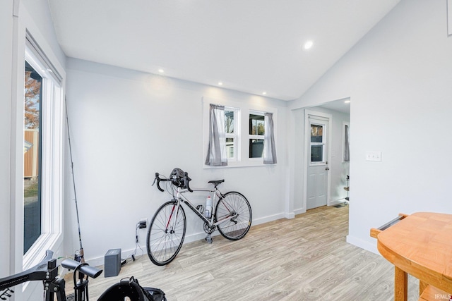 workout room with lofted ceiling, recessed lighting, baseboards, and light wood-style floors