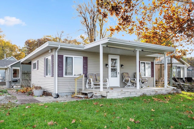 bungalow-style house featuring a porch and a front yard