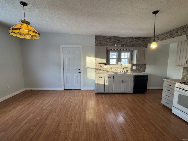 kitchen featuring a sink, dark wood-style floors, light countertops, dishwasher, and gas range gas stove