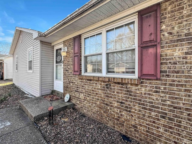 doorway to property with brick siding