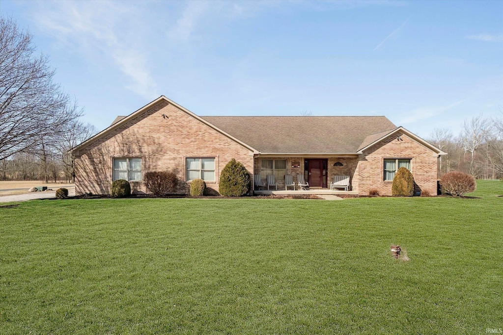 ranch-style house with brick siding and a front yard