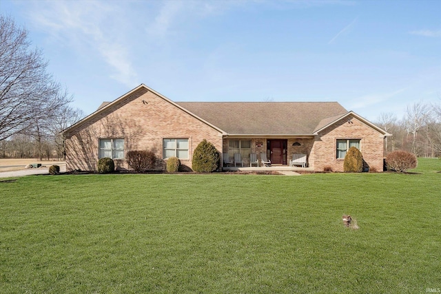 ranch-style house with brick siding and a front yard