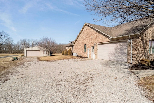 view of property exterior with driveway and brick siding