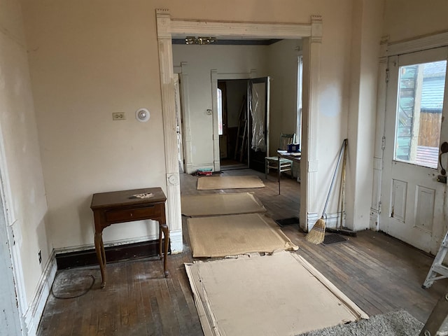 hallway with hardwood / wood-style flooring