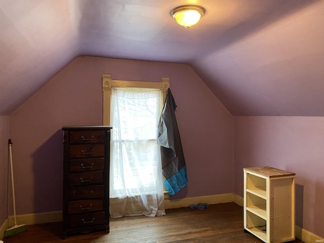 bonus room featuring lofted ceiling, baseboards, and wood finished floors