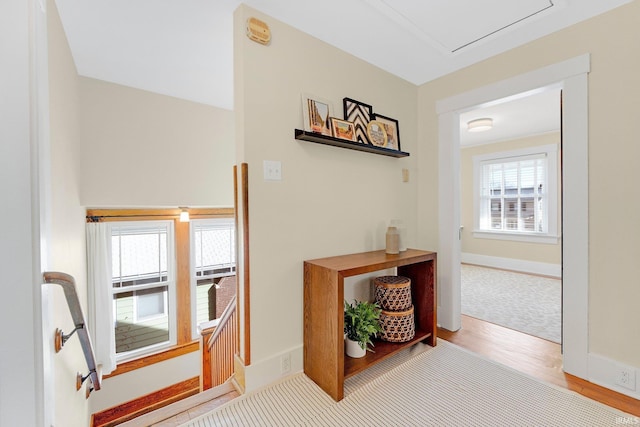 corridor with wood finished floors and baseboards