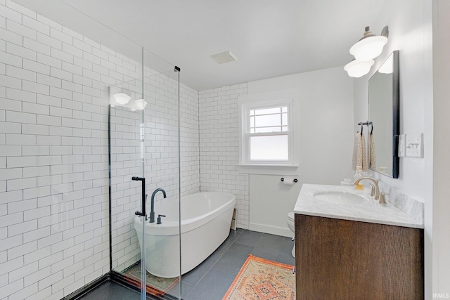 full bathroom featuring vanity, visible vents, a soaking tub, tile patterned floors, and a stall shower