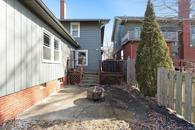 exterior space with an outdoor fire pit, crawl space, a patio area, fence, and a wooden deck