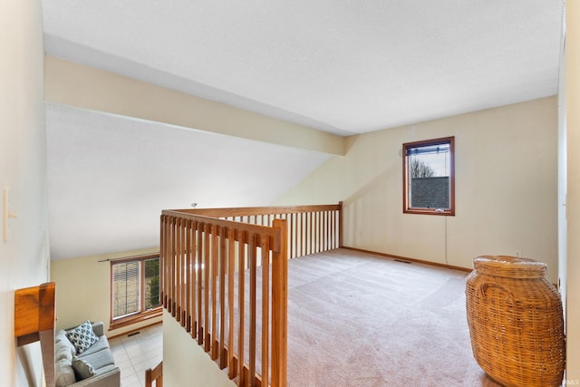 bonus room featuring carpet floors, visible vents, and lofted ceiling with beams