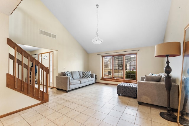 living room with light tile patterned floors, baseboards, visible vents, stairs, and high vaulted ceiling