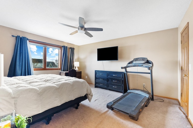 bedroom featuring light carpet, ceiling fan, and baseboards