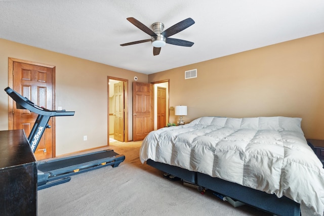 carpeted bedroom featuring baseboards, visible vents, and ceiling fan