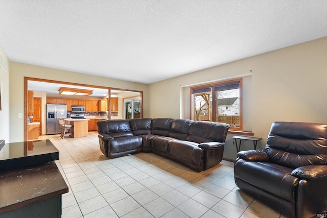 living room featuring a textured ceiling and light tile patterned flooring