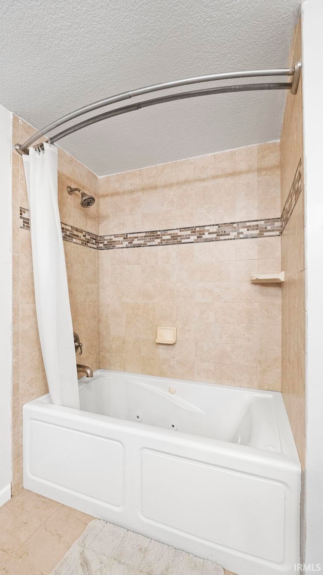 bathroom with a combined bath / shower with jetted tub, tile walls, and a textured ceiling