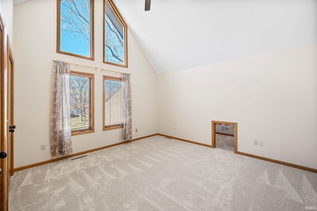 additional living space featuring high vaulted ceiling, carpet flooring, visible vents, and baseboards