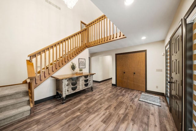 foyer entrance featuring recessed lighting, visible vents, wood finished floors, baseboards, and stairs