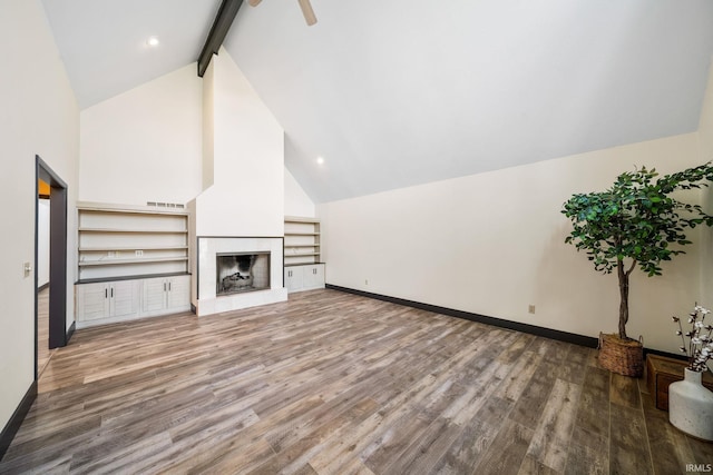 unfurnished living room with beam ceiling, a fireplace, visible vents, wood finished floors, and baseboards