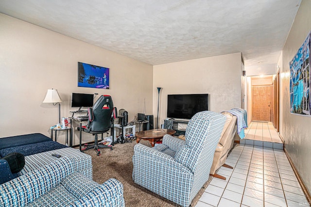 tiled living area with a textured ceiling and baseboards