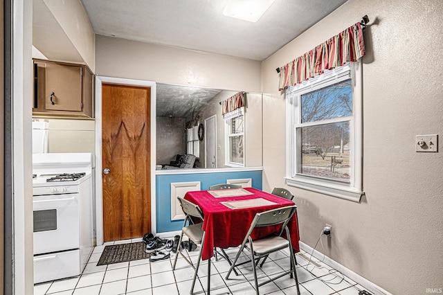 dining area with baseboards and light tile patterned floors