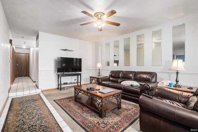 living area featuring light tile patterned floors and a ceiling fan