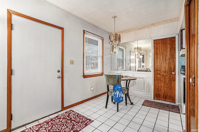 dining room with baseboards and light tile patterned floors