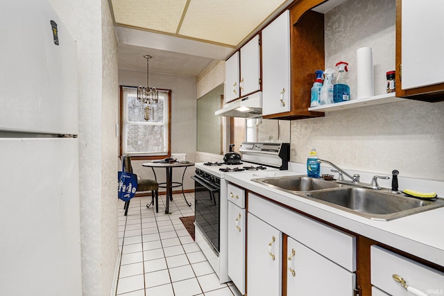 kitchen with white appliances, under cabinet range hood, light countertops, and a sink