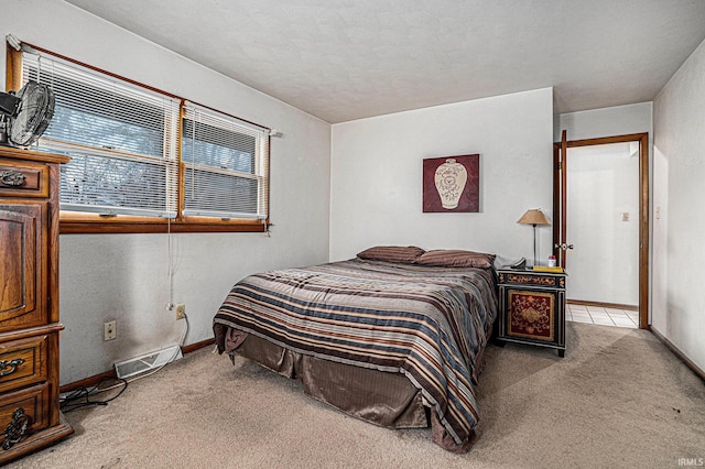 carpeted bedroom with baseboards and visible vents