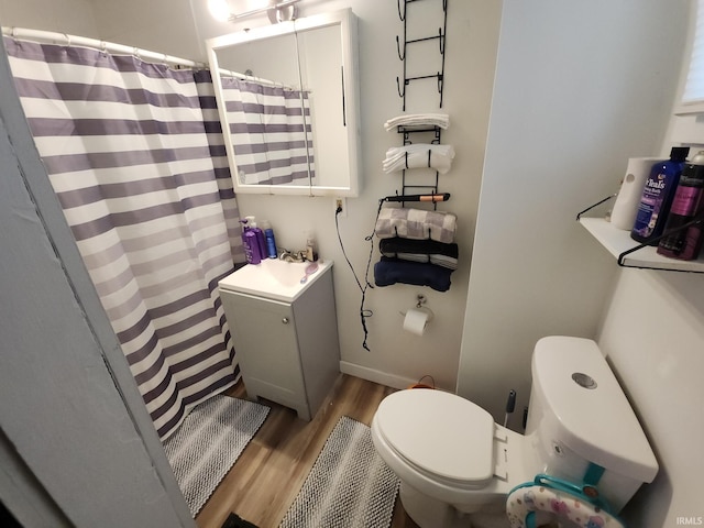 full bathroom with a shower with curtain, vanity, toilet, and wood finished floors