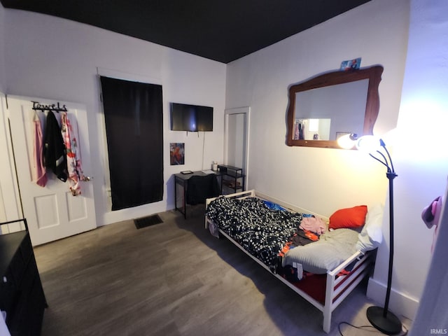 bedroom with wood finished floors and visible vents