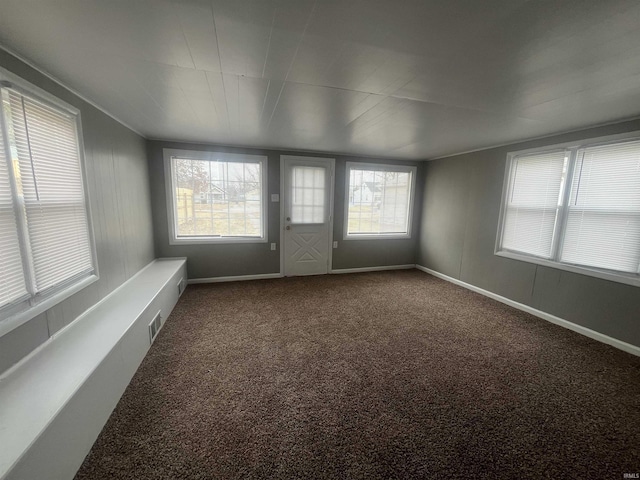 unfurnished sunroom featuring visible vents