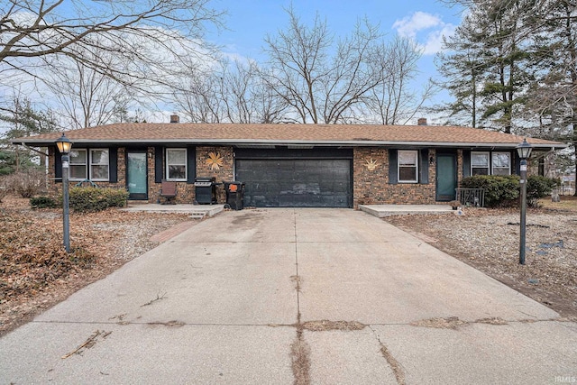 single story home featuring concrete driveway, brick siding, a chimney, and an attached garage