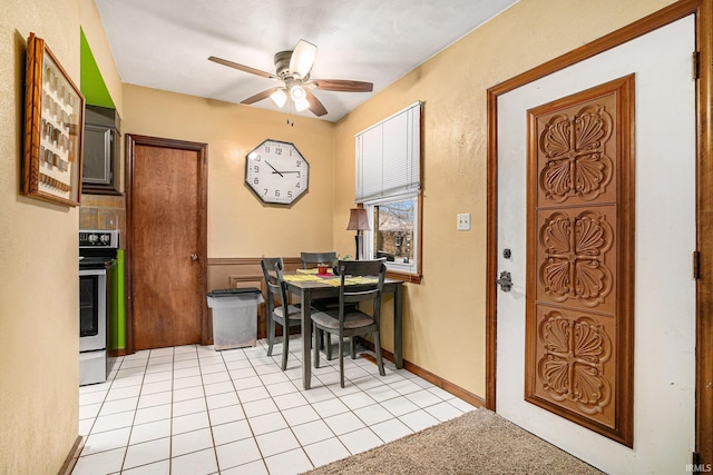 dining space featuring light tile patterned floors and ceiling fan