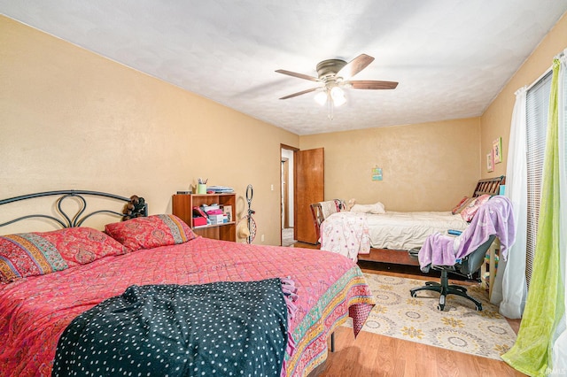 bedroom with ceiling fan and wood finished floors