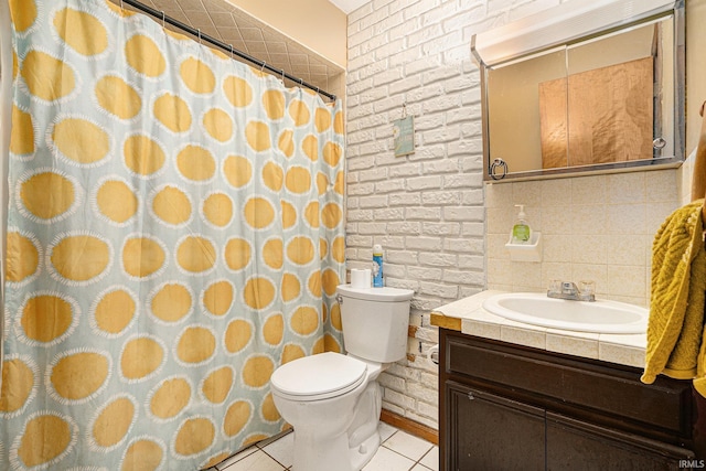 full bathroom with toilet, brick wall, tile patterned flooring, and vanity