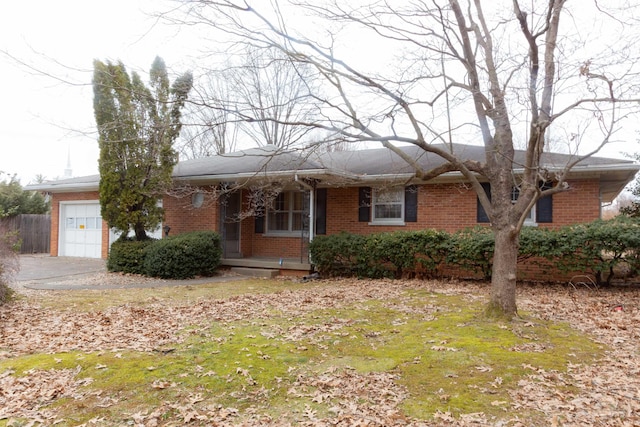 ranch-style home with a garage, a porch, and brick siding