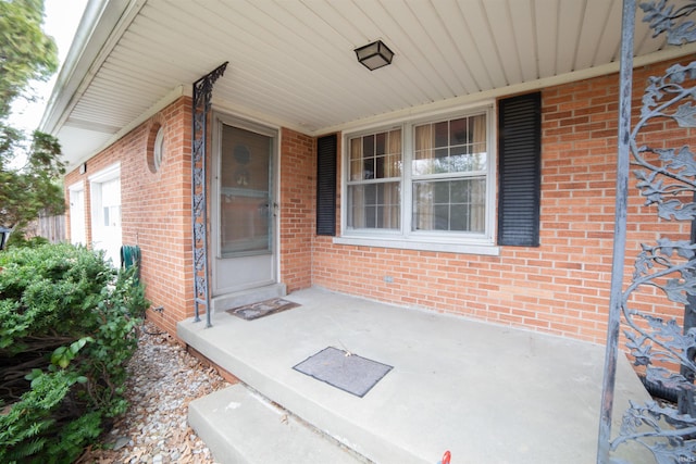 property entrance featuring brick siding