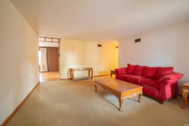 living area featuring carpet, visible vents, and baseboards