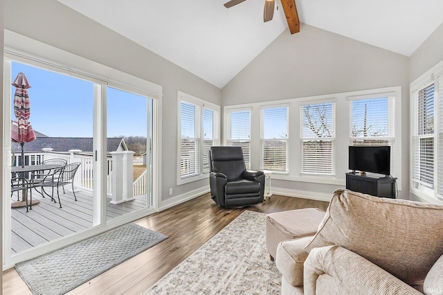 sunroom with vaulted ceiling with beams and a ceiling fan