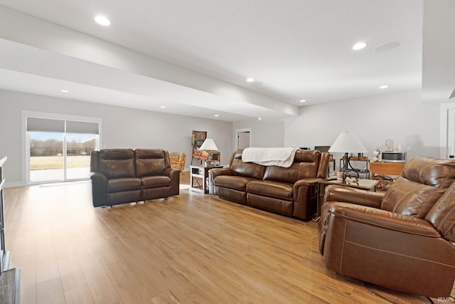 living room featuring light wood-type flooring and recessed lighting