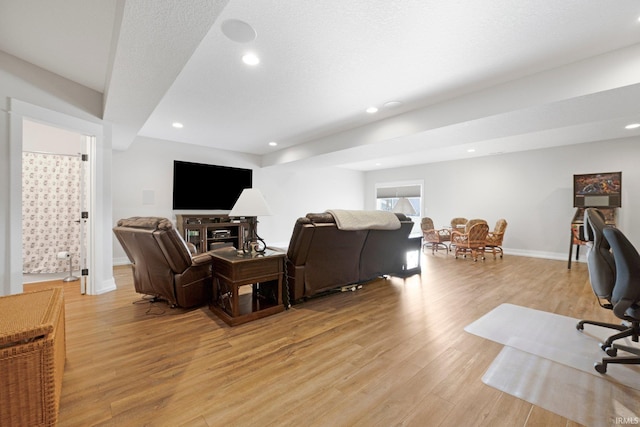 living area with baseboards, light wood-type flooring, and recessed lighting