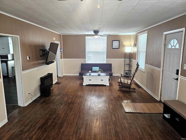 interior space featuring dark wood-type flooring, a healthy amount of sunlight, ceiling fan, and crown molding