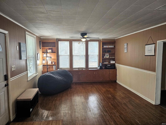 sitting room with visible vents, a ceiling fan, dark wood-style floors, crown molding, and built in shelves