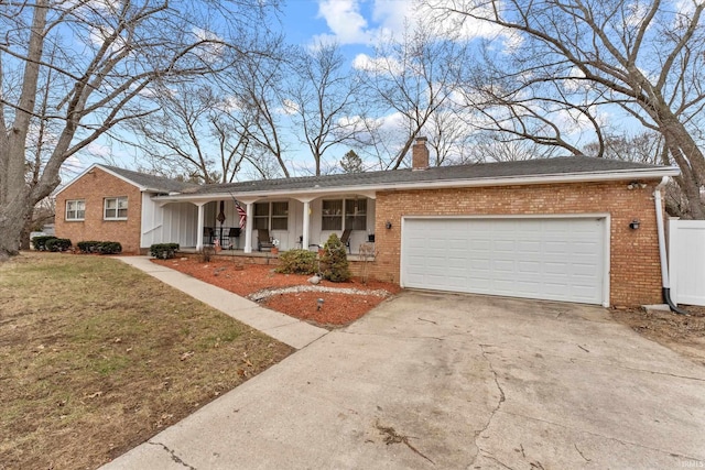 single story home featuring a porch, an attached garage, brick siding, driveway, and a chimney