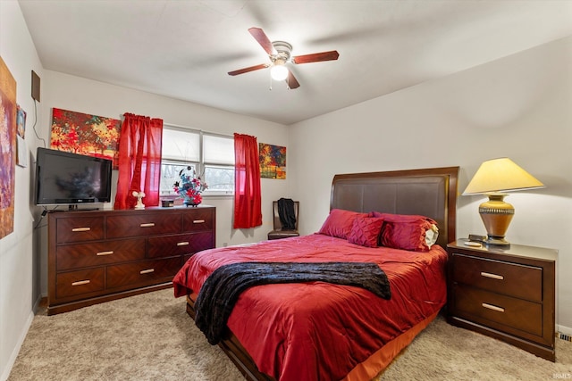 bedroom with light carpet, a ceiling fan, and baseboards