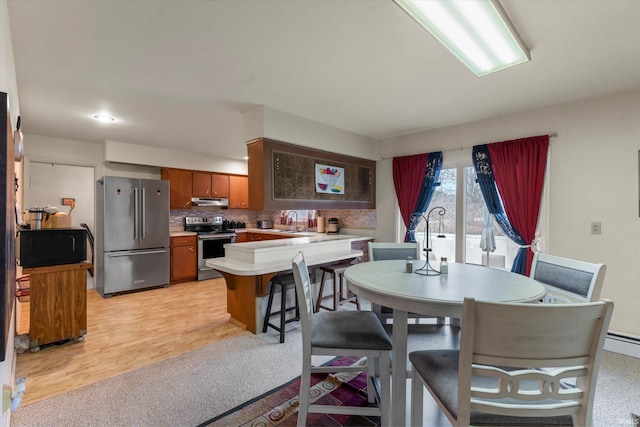 dining space featuring light wood-style floors