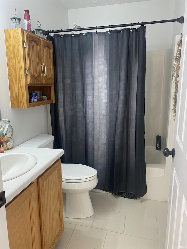 bathroom featuring tile patterned flooring, vanity, toilet, and shower / bath combo